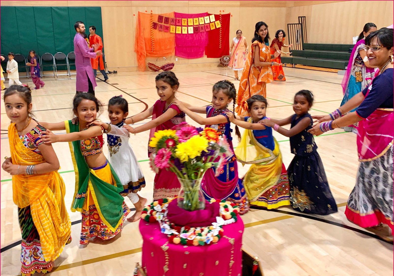 Children and families dancing Garba in a circle at the East Bay Family Garba